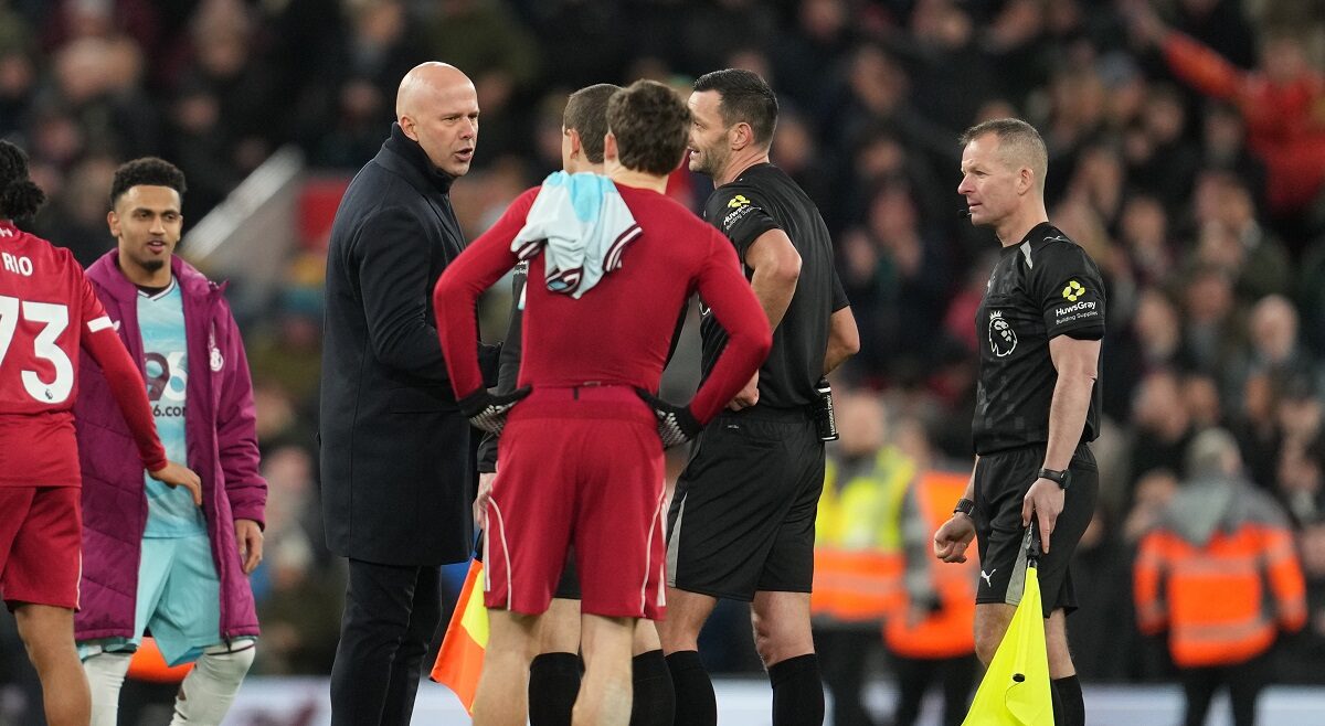 Liverpool's manager Arne Slot, left, talks with referee Andy Madley after the English Premier League soccer match between Liverpool and Burnley in Liverpool, England, Saturday, Jan. 17, 2026. (AP Photo/Jon Super)