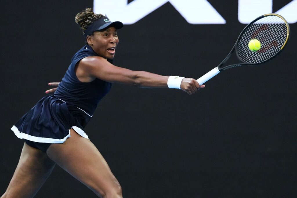 Venus Williams of the U.S. plays a backhand return to Olga Danilovic of Serbia during their first round match at the Australian Open tennis championship in Melbourne, Australia, Sunday, Jan. 18, 2026. (AP Photo/Aaron Favila)