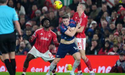 Arsenal's Viktor Gyokeres fights for the ball with Nottingham Forest's Nikola Milenkovic and Ola Aina, left, during the English Premier League soccer match between Nottingham Forest and Arsenal in Nottingham, England, Saturday, Jan. 17, 2026. (AP Photo/Dave Shopland)