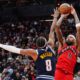 Toronto Raptors forward Brandon Ingram (3) shoots over Denver Nuggets guard Peyton Watson (8) during second half NBA action in Toronto on Wednesday Dec. 31, 2025. (Frank Gunn/The Canadian Press via AP)