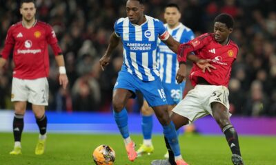 Brighton's Danny Welbeck, left, and Manchester United's Kobbie Mainoo fight for the ball during the FA Cup third round soccer match between Manchester United and Brighton in Manchester, England, Sunday, Jan. 11, 2026. (AP Photo/Jon Super)