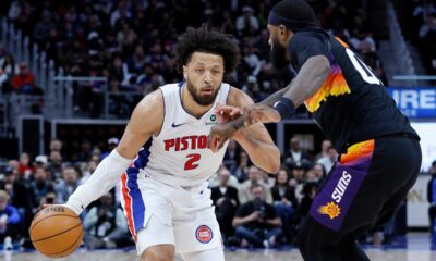 Detroit Pistons guard Cade Cunningham (2) drives against Phoenix Suns forward Royce O'Neale during the second half of an NBA basketball game, Thursday, Jan. 15, 2026, in Detroit. (AP Photo/Duane Burleson)