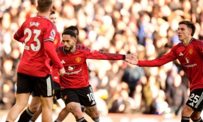 Manchester United's Matheus Cunha, center, celebrates after scoring his sides first goal during the English Premier League soccer match between Leeds United and Manchester United in Leeds, England, Sunday, Jan. 4, 2026. (Danny Lawson/PA via AP)