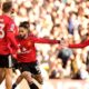 Manchester United's Matheus Cunha, center, celebrates after scoring his sides first goal during the English Premier League soccer match between Leeds United and Manchester United in Leeds, England, Sunday, Jan. 4, 2026. (Danny Lawson/PA via AP)