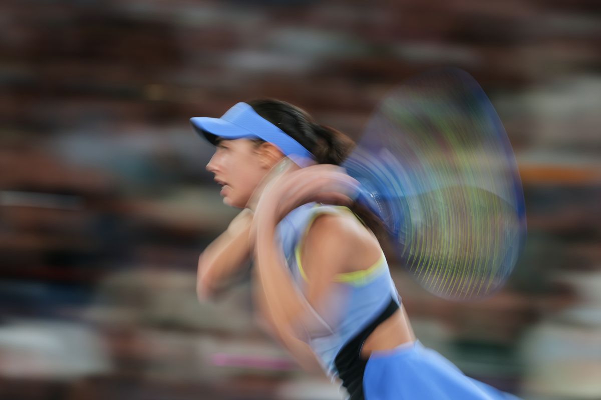Olga Danilovic of Serbia plays a backhand return to Venus Williams of the U.S. during their first round match at the Australian Open tennis championship in Melbourne, Australia, Sunday, Jan. 18, 2026. (AP Photo/Aaron Favila)