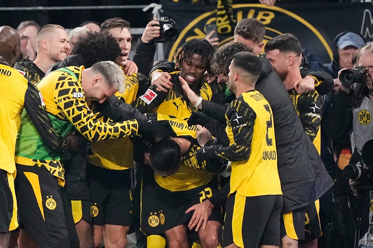 Dortmund's Emre Can is celebrated by his team after he scored his side's decisive third goal from the penalty spot during the German Bundesliga soccer match between Borussia Dortmund and St. Pauli in Dortmund, Germany, Saturday, Jan. 17, 2026. (AP Photo/Martin Meissner)