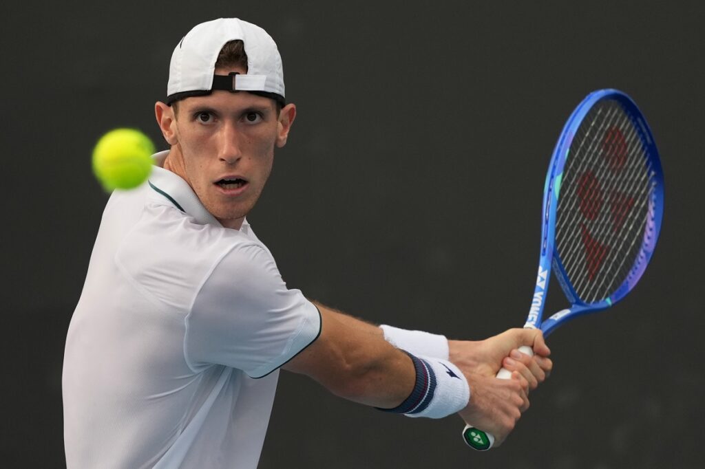 Francesco Maestrelli of Italy plays a backhand return to Terence Atmane of France during their first round match at the Australian Open tennis championship in Melbourne, Australia, Monday, Jan. 19, 2026. (AP Photo/Dar Yasin)