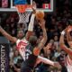 Toronto Raptors center Mo Bamba (11) and forward Scottie Barnes, right, defend against Orlando Magic forward Paolo Banchero (5) as he shoots during first half NBA action in Toronto on Monday Dec. 29, 2025. THE (Frank Gunn/The Canadian Press via AP)