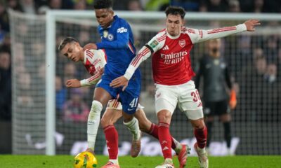 Chelsea's Estevao, center, is challenged by Arsenal's Martin Zubimendi, right, and Leandro Trossard during the English League Cup semifinal first leg soccer match between Chelsea and Arsenal in London, Wednesday, Jan. 14, 2026. (AP Photo/Alastair Grant)