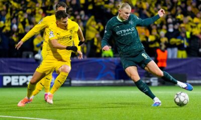 Manchester City's Erling Haaland, right, and Glimt's Jostein Gundersen battle for the ball during the Champions League soccer match between Bodo/Glimt and Manchester City in Bodo, Norway, Tuesday, Jan. 20, 2026. (Fredrik Varfjell/NTB via AP)