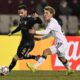 Qarabag's Marko Jankovic, left, and Frankfurt's Ritsu Doan chase the ball during the Champions League opening phase soccer match between Qarabag and Eintracht Frankfurt in Baku, Azerbaijan, Wednesday, Jan. 21, 2026. (AP Photo)