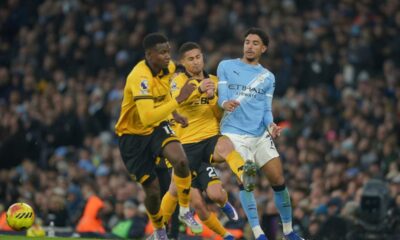 Manchester City's Omar Marmoush, right loses possession to Wolverhampton Wanderers' Rodrigo Gomes during the English Premier League soccer match between Manchester City and Wolverhampton Wanderers in Manchester, England, Saturday, Jan. 24, 2026. (AP Photo/Ian Hodgson)