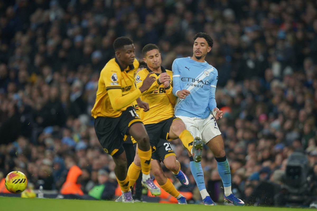 Manchester City's Omar Marmoush, right loses possession to Wolverhampton Wanderers' Rodrigo Gomes during the English Premier League soccer match between Manchester City and Wolverhampton Wanderers in Manchester, England, Saturday, Jan. 24, 2026. (AP Photo/Ian Hodgson)