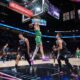 Boston Celtics guard Jordan Walsh (27) dunks over Miami Heat forward Nikola Jovic (5) and guard Pelle Larsson during the first half of an NBA basketball game, Thursday, Jan. 15, 2026, in Miami. (AP Photo/Rebecca Blackwell)