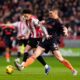 Brentford's Kevin Schade, left, and Nottingham Forest's Nikola Milenkovic battle for the ball during their English Premier League soccer match in London, Sunday, Jan. 25, 2026. (Nick Potts/PA via AP)