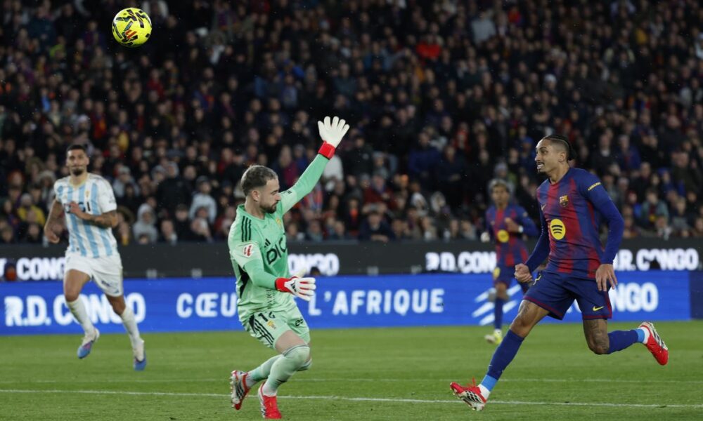 Barcelona's Raphinha, right, scores his side's second goal during a Spanish La Liga soccer match between Barcelona and Real Oviedo in Barcelona, Spain, Sunday, Jan. 25, 2026. (AP Photo/Joan Monfort)