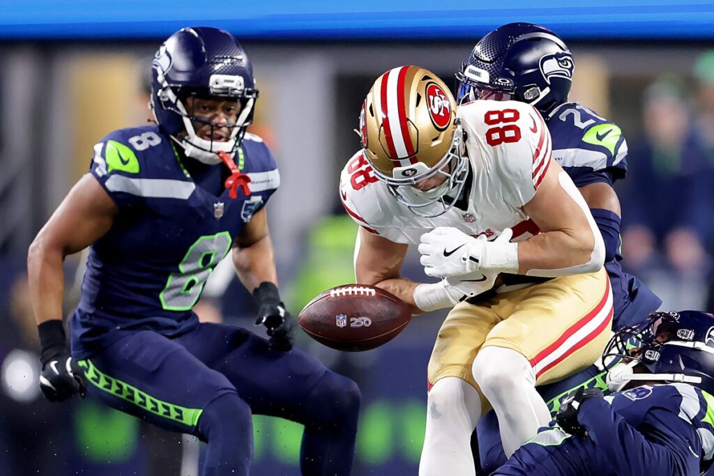 San Francisco 49ers Jake Tonges (88) fumbles the ball during the first half of an NFL football divisional playoff game against the Seattle Seahawks, Saturday, Jan. 17, 2026, in Seattle. (Scott Strazzante/San Francisco Chronicle via AP)