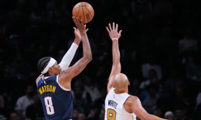 Denver Nuggets guard Peyton Watson (8) shoots over Boston Celtics guard Derrick White (9) during the second half of an NBA basketball game, Wednesday, Jan. 7, 2026, in Boston. (AP Photo/Charles Krupa)