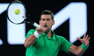 Novak Djokovic of Serbia plays a forehand return to Pedro Martinez of Spain during their first round match at the Australian Open tennis championship in Melbourne, Australia, Monday, Jan. 19, 2026. (AP Photo/Aaron Favila)