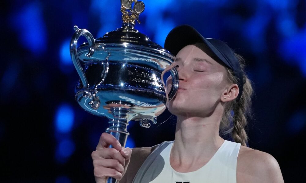 Elena Rybakina of Kazakhstan kisses the Daphne Akhurst Memorial Cup after defeating Aryna Sabalenka of Belarus to win the women's singles final at the Australian Open tennis championship in Melbourne, Australia, Saturday, Jan. 31, 2026. (AP Photo/Aaron Favila)