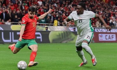 Morocco's Brahim Abdelkader Díaz sends a cross by Nigeria's Calvin Bassey during the Africa Cup of Nations semi-final match between Nigeria and Morocco in Rabat, Morocco, Wednesday, Jan. 14, 2026. (AP Photo/Youssef Loulidi)