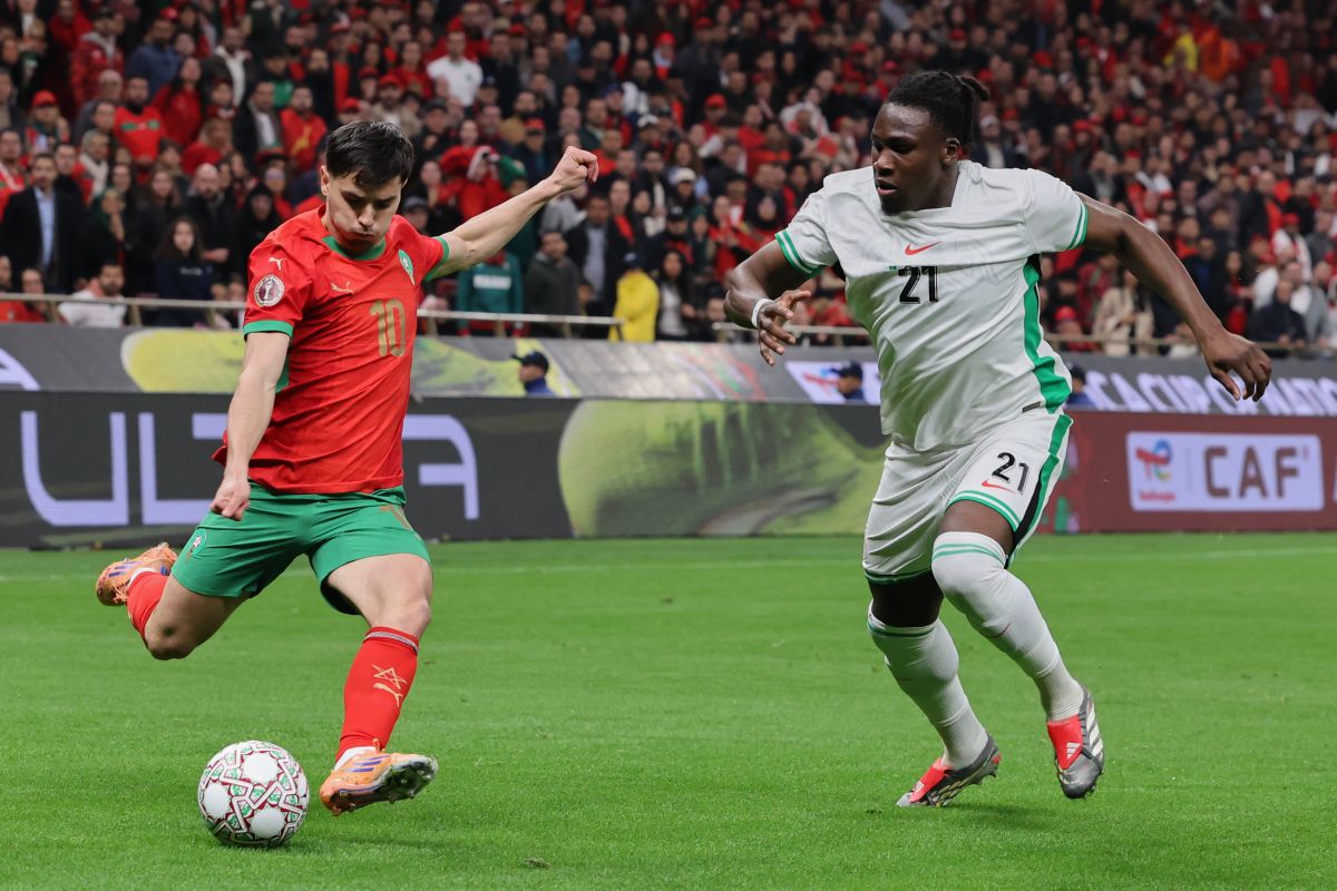 Morocco's Brahim Abdelkader Díaz sends a cross by Nigeria's Calvin Bassey during the Africa Cup of Nations semi-final match between Nigeria and Morocco in Rabat, Morocco, Wednesday, Jan. 14, 2026. (AP Photo/Youssef Loulidi)