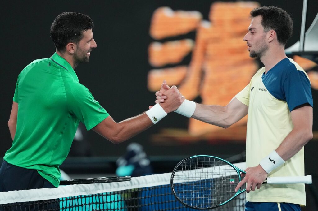Novak Djokovic, left, of Serbia celebrates after defeating Pedro Martinez of Spain in their first round match at the Australian Open tennis championship in Melbourne, Australia, Monday, Jan. 19, 2026. (AP Photo/Aaron Favila)