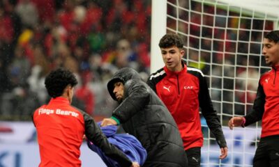A ball boy attempts to grab a towel from Senegal's second-choice goalkeeper Yéhvann Diouf as he holds it for Senegal's goalkeeper Edouard Mendy, during the Africa Cup of Nations final soccer match between Senegal and Morocco, in Rabat, Morocco, Sunday, Jan. 18, 2026. (AP Photo/Mosa'ab Elshamy)