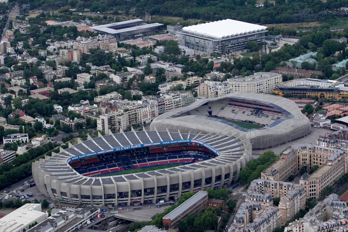 FILE - The Parc des Princes stadium, center, which hosts the Paris Saint-Germain soccer team, and the Jean Bouin stadium, right, which hosts the Paris FC soccer team are seen in Paris, France, Tuesday, July 11, 2023. Atop is the Roland Garros stadium. (AP Photo/Christophe Ena, File)