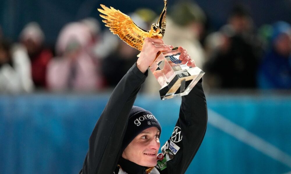 Domen Prevc, of Slovenia, celebrates with his golden eagle trophy after winning the Four Hills ski jumping tournament in Bischofshofen, Austria, Tuesday, Jan. 6, 2026. (AP Photo/Matthias Schrader)