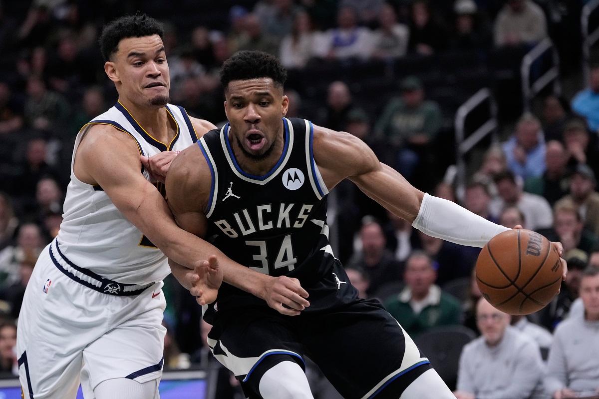 Milwaukee Bucks' Giannis Antetokounmpo (34) tries to get past Denver Nuggets' Spencer Jones during the second half of an NBA basketball game Friday, Jan. 23, 2026, in Milwaukee. (AP Photo/Morry Gash)