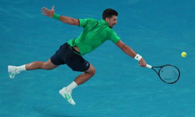 Novak Djokovic of Serbia plays a backhand return to Pedro Martinez of Spain during their first round match at the Australian Open tennis championship in Melbourne, Australia, Monday, Jan. 19, 2026. (AP Photo/Aaron Favila)