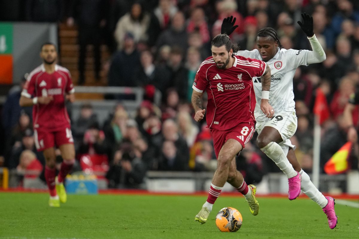 Barnsley's Reyes Cleary runs after Liverpool's Dominik Szoboszlai during the FA Cup third round soccer match between Liverpool and Barnsley in Liverpool, England, Monday, Jan. 12, 2026. (AP Photo/Jon Super)
