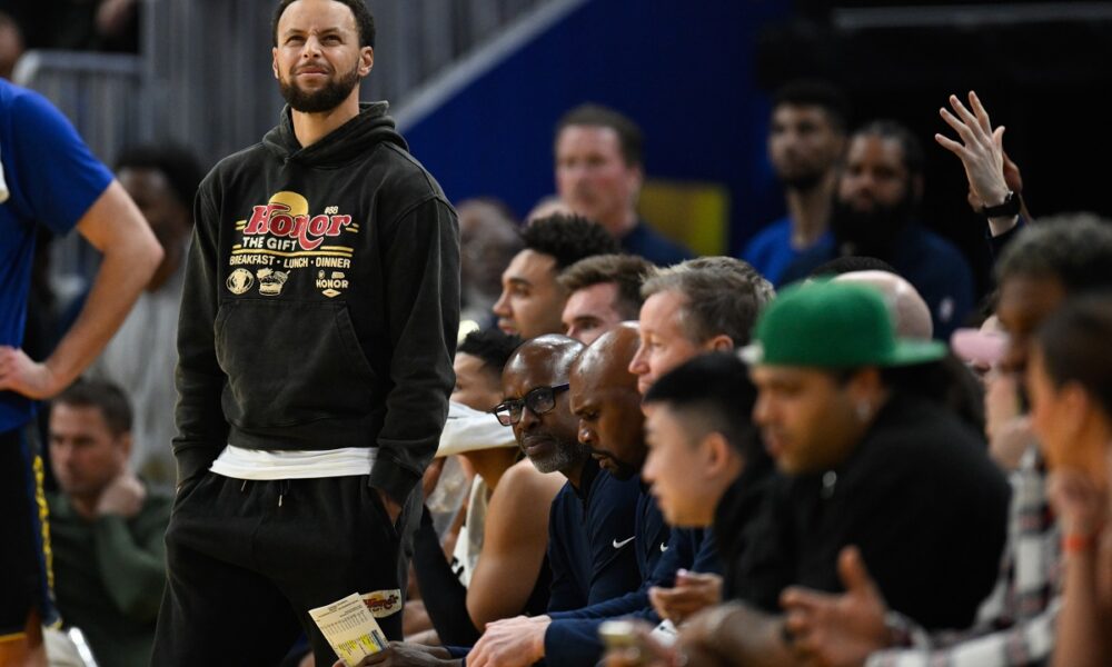 Golden State Warriors guard Stephen Curry stands by the team bench against the Philadelphia 76ers during the first half of an NBA basketball game Tuesday, Feb. 3, 2026, in San Francisco. (AP Photo/Eakin Howard)