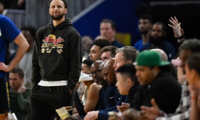 Golden State Warriors guard Stephen Curry stands by the team bench against the Philadelphia 76ers during the first half of an NBA basketball game Tuesday, Feb. 3, 2026, in San Francisco. (AP Photo/Eakin Howard)