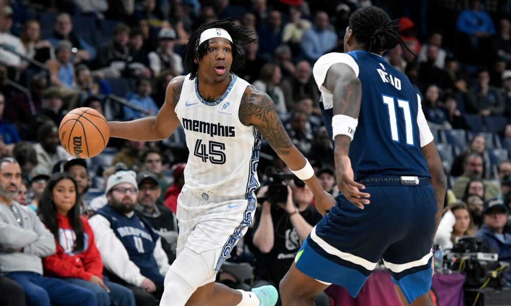 Memphis Grizzlies forward GG Jackson II (45) handles the ball against Minnesota Timberwolves center Naz Reid (11) in the second half of an NBA basketball game Monday, Feb. 2, 2026, in Memphis, Tenn. (AP Photo/Brandon Dill)