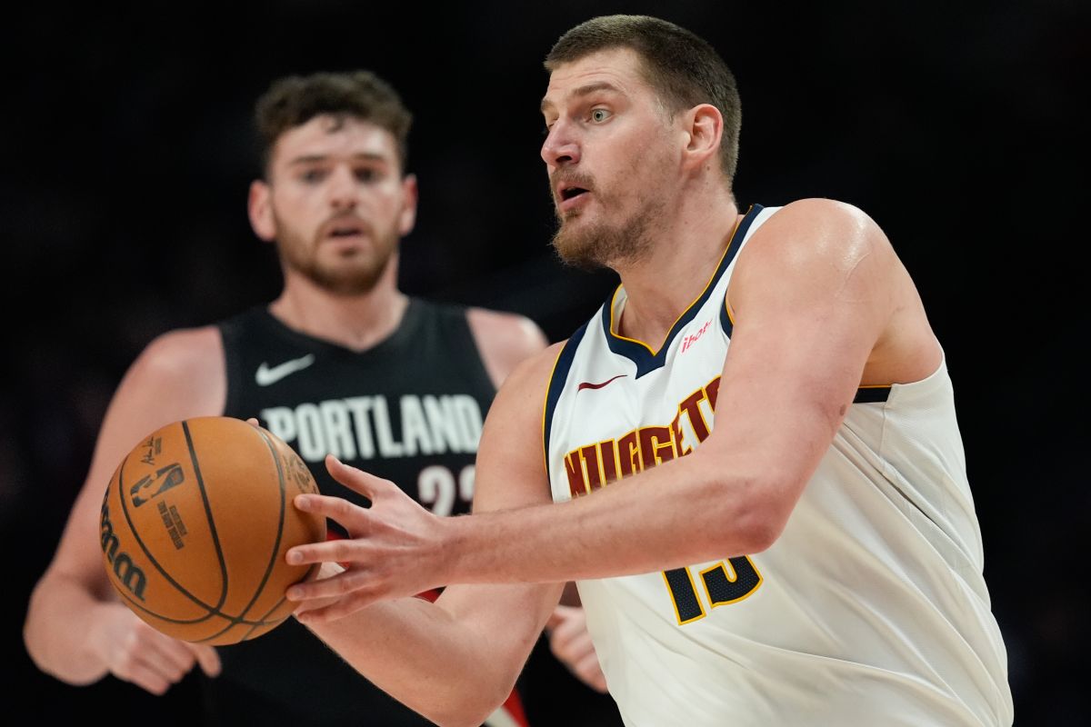 Denver Nuggets center Nikola Jokić looks to pass the ball during the second half of an NBA basketball game against the Portland Trail Blazers, Friday, Feb. 20, 2026, in Portland, Ore. (AP Photo/Jenny Kane)