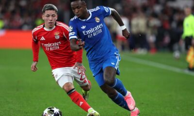Benfica's Gianluca Prestianni fights for the ball against Real Madrid's Vinicius Junior during a Champions League playoff soccer match between SL Benfica and Real Madrid in Lisbon, Portugal, Tuesday, Feb. 17, 2026. (AP Photo/Pedro Rocha)