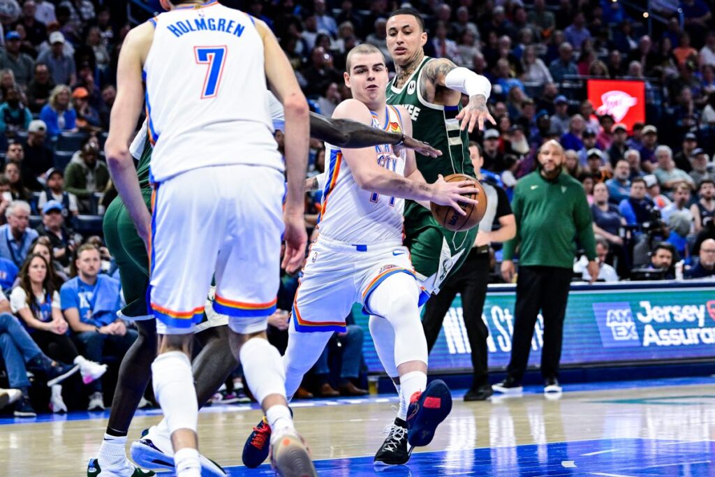 Oklahoma City Thunder guard Nikola Topić, center, drives against the Milwaukee Bucks during the second half of an NBA basketball game, Thursday, Feb. 12, 2026, in Oklahoma City. (AP Photo/Gerald Leong)