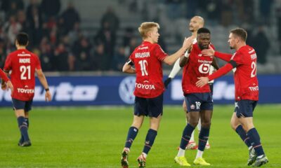Lille's Perrin Gaetan, right, celebrates after scoring his side's first goal during the French League One soccer match between Lille and Brest in Villeneuve-d'Ascq, outside Lille, France, Saturday, Feb. 14, 2026. (AP Photo/Jean-Francois Badias)