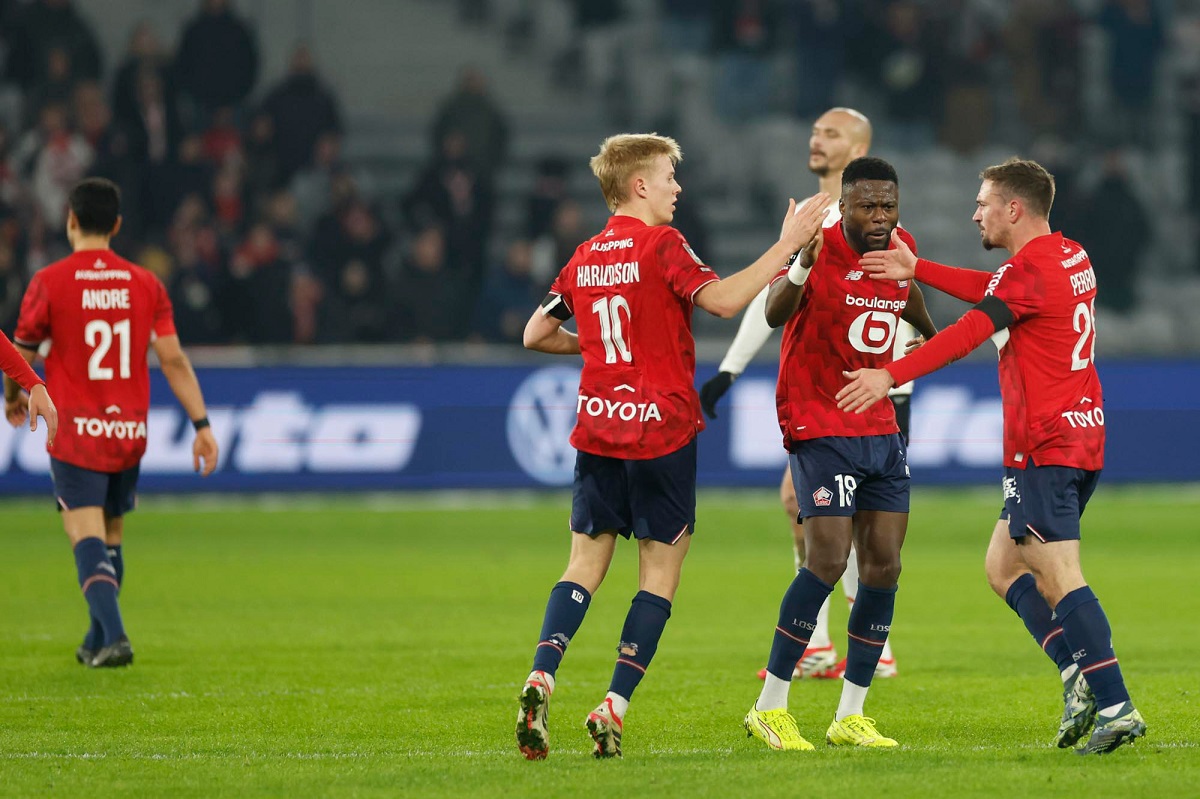Lille's Perrin Gaetan, right, celebrates after scoring his side's first goal during the French League One soccer match between Lille and Brest in Villeneuve-d'Ascq, outside Lille, France, Saturday, Feb. 14, 2026. (AP Photo/Jean-Francois Badias)