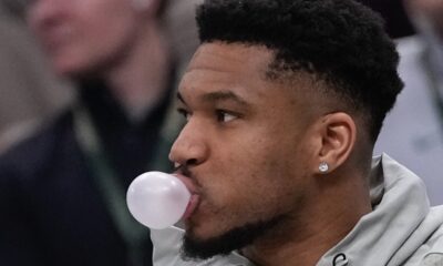 Milwaukee Bucks' Giannis Antetokounmpo blows a bubble on the bench during the first half of an NBA basketball game Tuesday, Feb. 3, 2026, in Milwaukee. (AP Photo/Morry Gash)