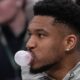 Milwaukee Bucks' Giannis Antetokounmpo blows a bubble on the bench during the first half of an NBA basketball game Tuesday, Feb. 3, 2026, in Milwaukee. (AP Photo/Morry Gash)