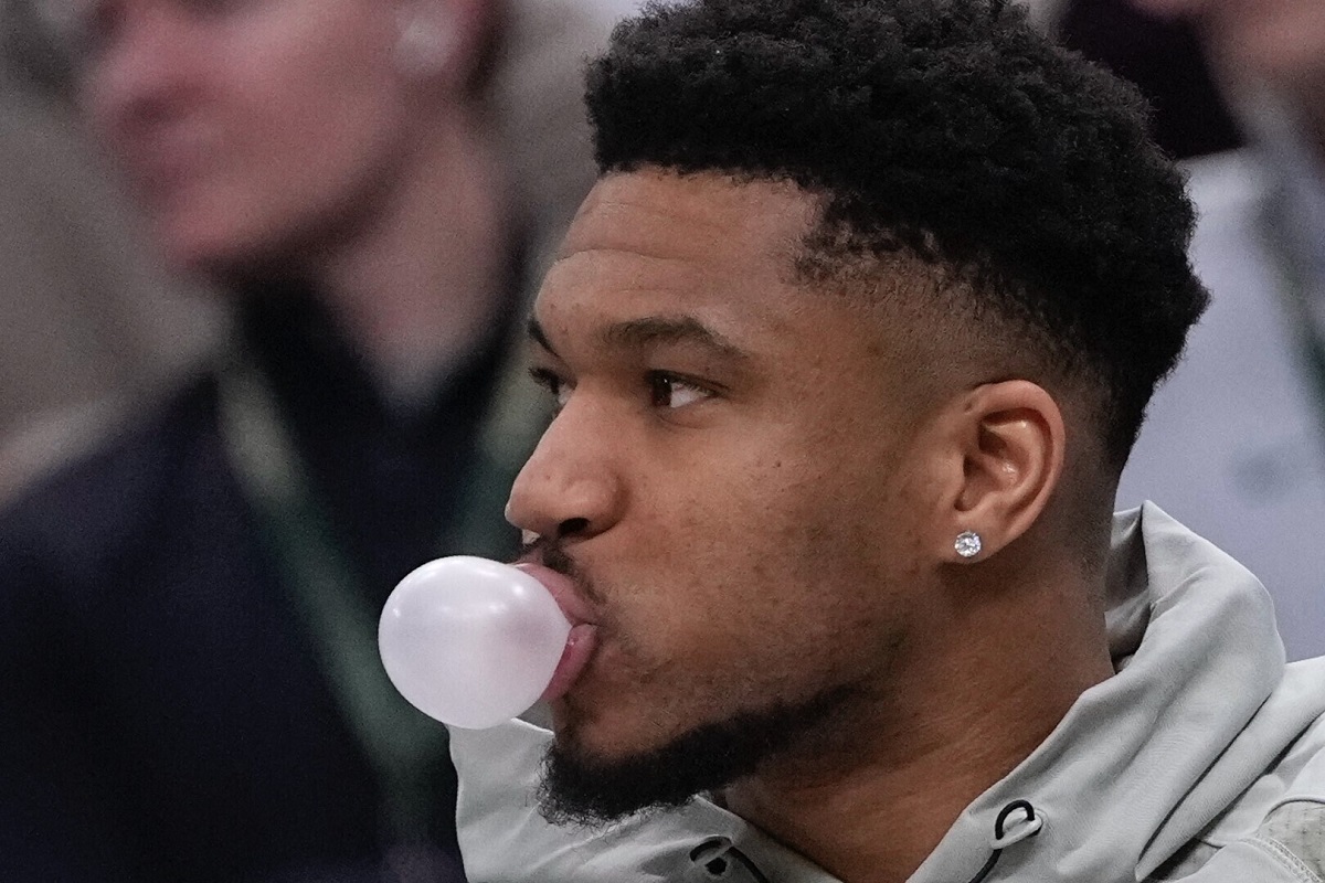 Milwaukee Bucks' Giannis Antetokounmpo blows a bubble on the bench during the first half of an NBA basketball game Tuesday, Feb. 3, 2026, in Milwaukee. (AP Photo/Morry Gash)