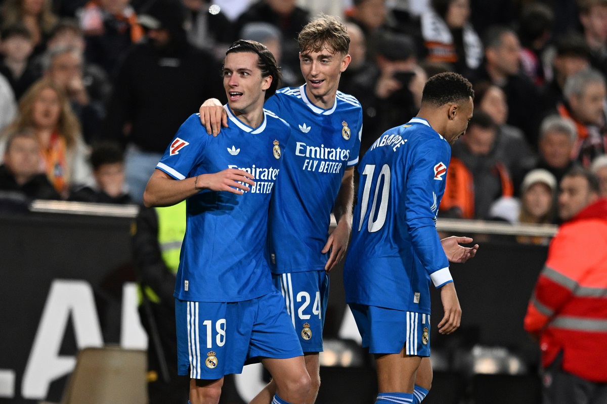 Real Madrid's Alvaro Carreras, left, celebrates with Dean Huijsen, centre and Kylian Mbappe after scoring the opening goal during the Spanish La Liga soccer match between Valencia and Real Madrid in Valencia, Spain, Sunday, Feb. 8, 2026. (AP Photo/Francisco Macia)