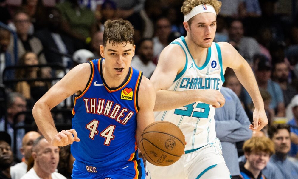 FILE - Oklahoma City Thunder guard Nikola Topic, left, drives the ball upcourt against Charlotte Hornets forward Liam McNeeley, right, during the second half of an NBA basketball preseason game in North Charleston, S.C., Oct. 5, 2025. (AP Photo/Mic Smith, File)