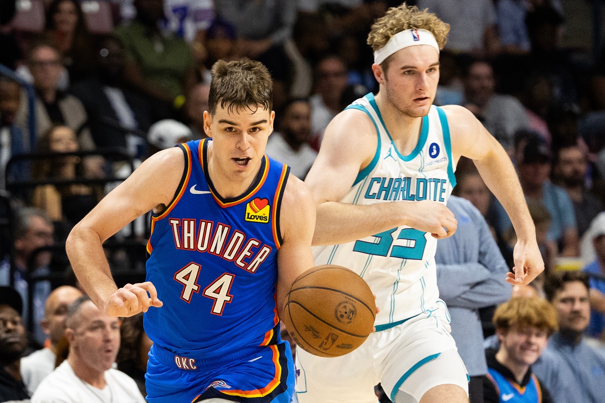 FILE - Oklahoma City Thunder guard Nikola Topic, left, drives the ball upcourt against Charlotte Hornets forward Liam McNeeley, right, during the second half of an NBA basketball preseason game in North Charleston, S.C., Oct. 5, 2025. (AP Photo/Mic Smith, File)