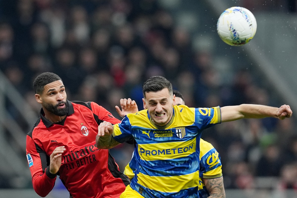 AC Milan's Ruben Loftus-Cheek, left, fights for the bass with Parma's Emanuele Valeri during the Italian Serie A soccer match between AC Milan and Parma in Milan, Italy, Sunday, Feb. 22 , 2025. (Spada/LaPresse via AP)