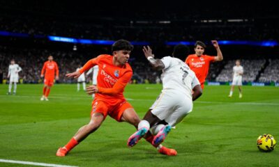 Real Sociedad's Jon Aramburu, left, fouls Real Madrid's Vinicius Junior in the penalty area during the Spanish La Liga soccer match between Real Madrid and Real Sociedad in Madrid, Spain, Saturday, Feb. 14, 2026. (AP Photo/Manu Fernandez)