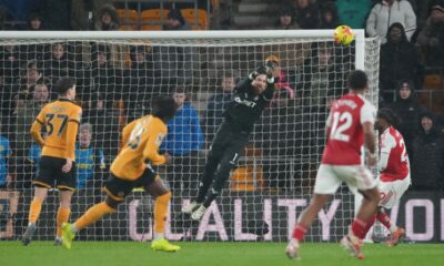 Wolverhampton Wanderers' goalkeeper Jose Sa, center, saves a shot during the Premier League soccer match between Wolverhampton Wanderers and Arsenal in Wolverhampton, England, Wednesday, Feb. 18, 2026. (AP Photo/Dave Shopland)